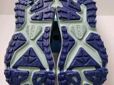 the soles of a pair of blue and green running shoes
