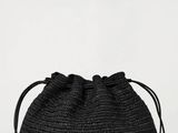 a picture of a black straw bag on a white background