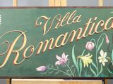 a sign that reads villa romantica on a easel