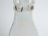 a white vase that is sitting on a white surface