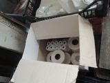 many rolls of toilet paper in a carton on the floor