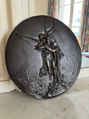 a black plate with a picture of a man and a woman on it