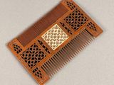 a wooden comb that has a design on it
