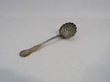 a spoon that is sitting on a white surface