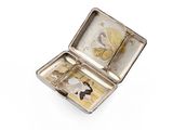 a small metal box with a picture of a woman inside of it