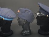 three hats are lined up on top of a mannequin head
