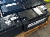 many different batteries on a pallet in a warehouse