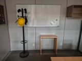 a picture of a room with a table and a hat rack