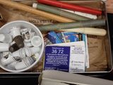 a metal container filled with assorted items on a table