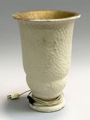 a white vase that has a cord attached to it