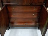 a wooden chest with drawers and a mirror in it