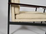 the chair is made of wood and has a beige upholstered seat