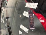 a sticker on the windshield of a car that has a ruler attached to it