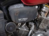 a close up of a motorcycle engine with a red cover
