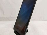 a tablet computer sitting on top of a stand on top of a white surface