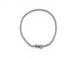 a close up of a bracelet on a white surface