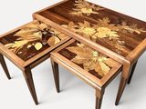 three wooden tables with flowers painted on them sitting on a white surface