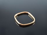 a close up of a gold ring sitting on top of a black surface