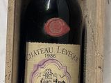 a bottle of wine in a wooden box on a table