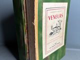 un vieux livre vert sur lequel figure l'image d'un chien