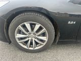 a close up of a car ' s tire on the pavement