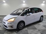 a picture of a small white car in a showroom
