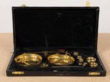 a black case with a set of brass objects in it