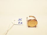 a gold ring with a coin on it next to a price tag