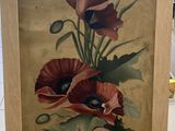 une photo d'un tableau représentant des fleurs posé sur un chevalet