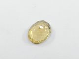 a close up of a yellow diamond on a white surface