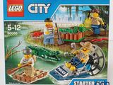 a box of lego city set with a man on a boat