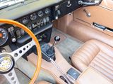a dashboard and steering wheel of a car with a clock on it