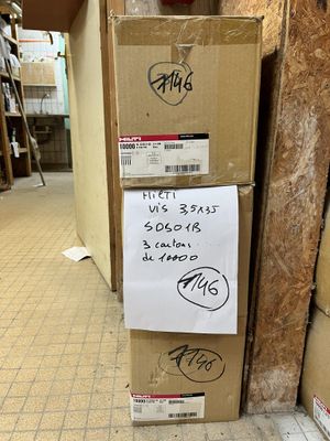 a stack of boxes sitting on the floor next to a wall