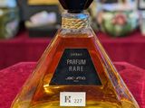 an image of a bottle of perfume sitting on a table