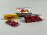 a red toy truck and a red toy car next to each other