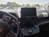 a car dashboard with a steering wheel and a cell phone in it