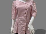 an image of a mannequin wearing a pink shirt and black skirt