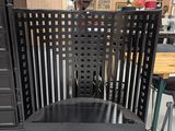 a black chair that is sitting in front of a dresser