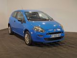 a picture of a small blue car parked in a showroom