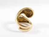 a close up of a gold ring on a white surface