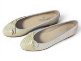 pair of women ' s shoes on a white surface with a white background