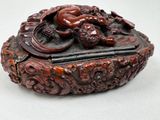 a small box with a dragon on it on a table