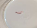 a close up of a white plate with a red inscription on it
