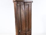 a small wooden cabinet with a door on it