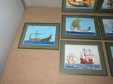 four framed pictures of ships on the wall