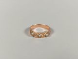 a close up of a gold ring on a white surface