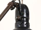 a close up of a black lamp with a wooden handle