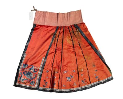 an orange and black skirt with a floral design on it