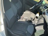 the interior of a car with the door open and the driver ' s seat down