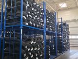 many tires stacked on a rack in a warehouse